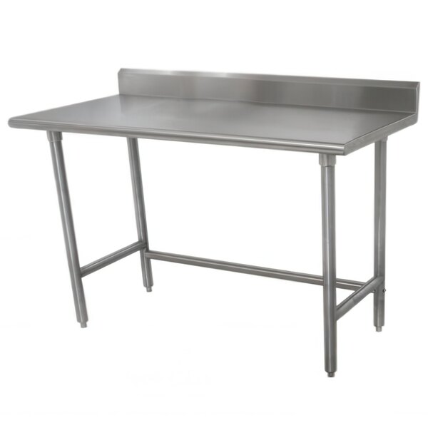 A stainless steel Advance Tabco work table with a backsplash.