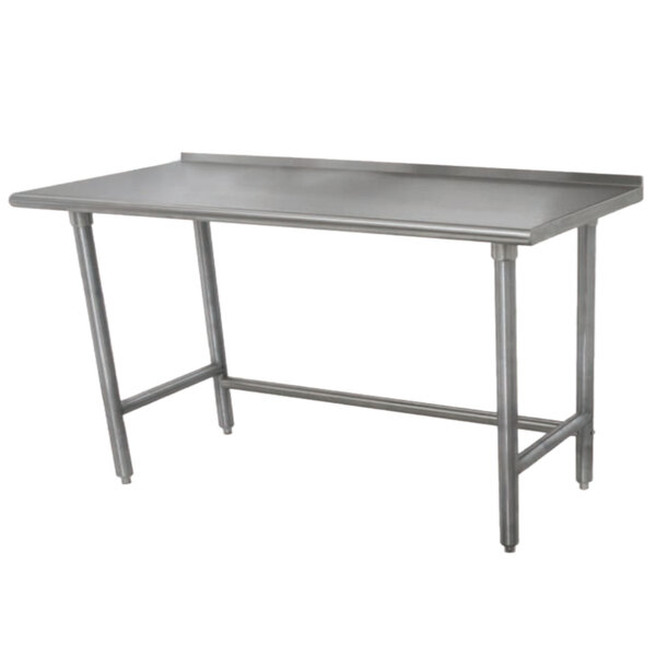 An Advance Tabco stainless steel work table with legs and a backsplash.