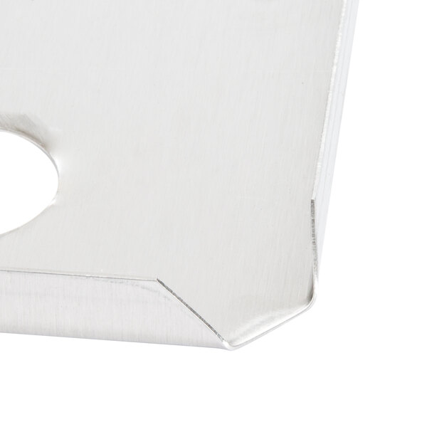 A close up of a stainless steel Carlisle fountain jar cover with a white circle in the middle.