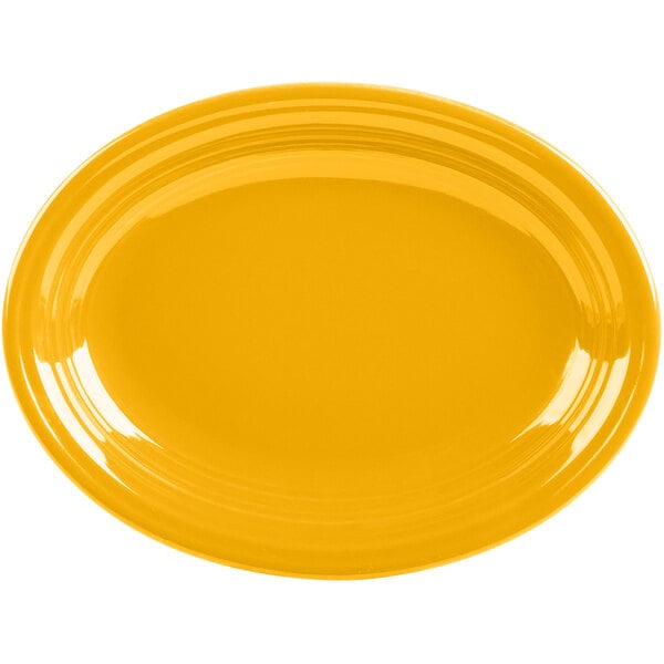 A yellow oval Fiesta china platter on a white background.