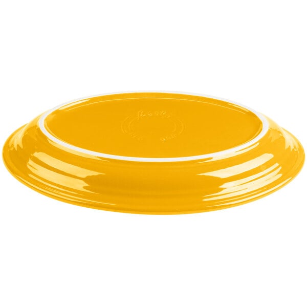 A yellow oval china platter with a white rim.