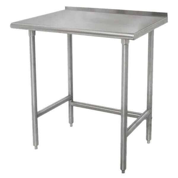 An Advance Tabco stainless steel work table with legs and a backsplash.