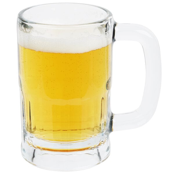 A Libbey glass beer mug filled with beer on a white background.