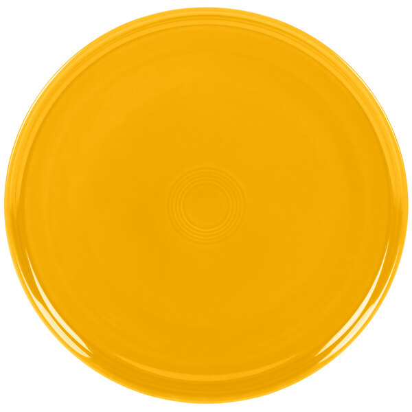 A yellow plate with a circle pattern on the rim.