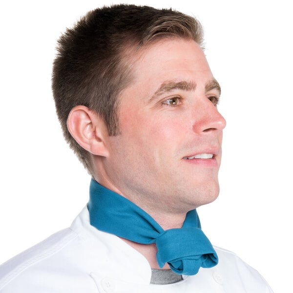 A man wearing a teal Intedge chef neckerchief around his neck.