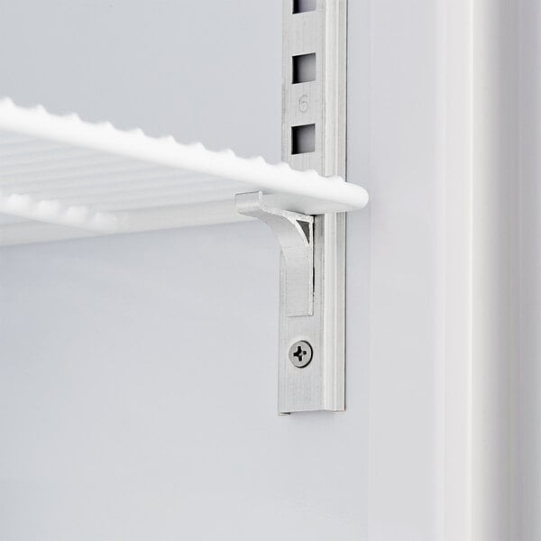 A white metal shelf in an Avantco countertop display freezer.