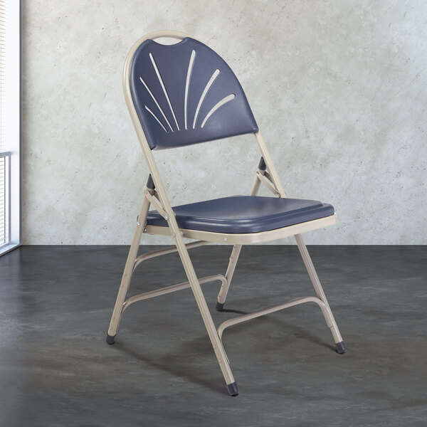 A gray metal National Public Seating folding chair with a dark blue plastic seat.