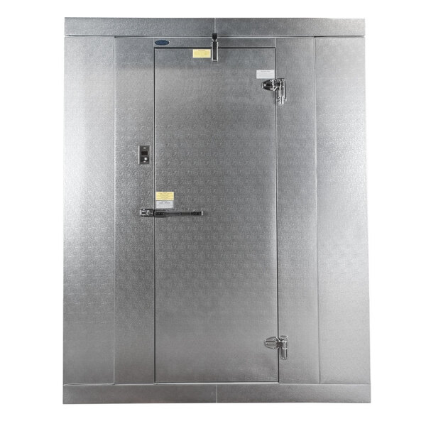 A large, metallic outdoor walk-in cooler with a single door and heavy-duty latches.