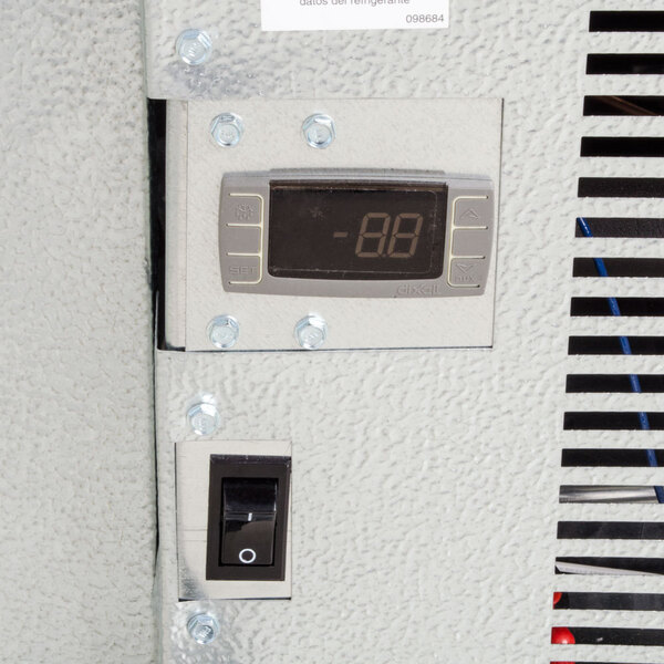 A digital control panel and power switch on the exterior of a walk-in cooler.
