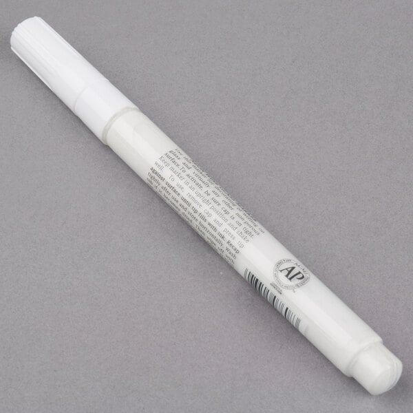 A Franmara neon white mini tip marker with a white cap on a gray surface.