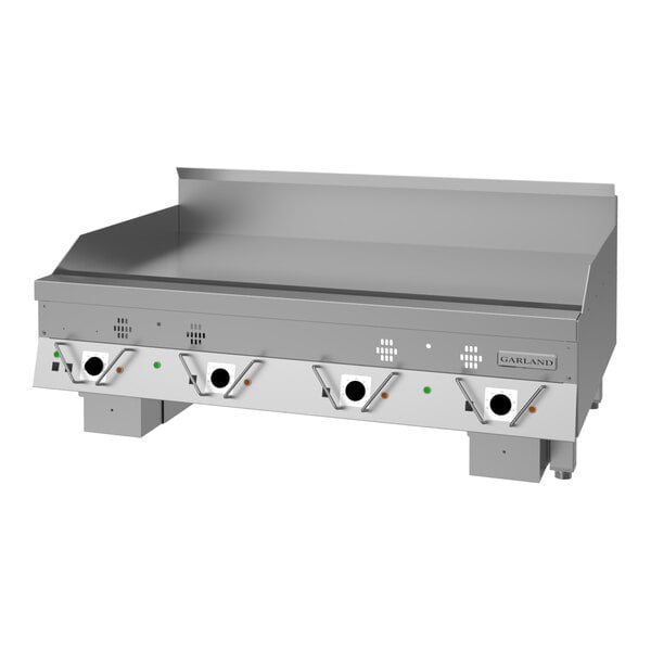 A large stainless steel commercial griddle with four control knobs and a backsplash, designed for high-volume cooking.