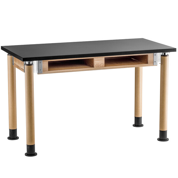 A black and wood National Public Seating science lab table with book compartments.