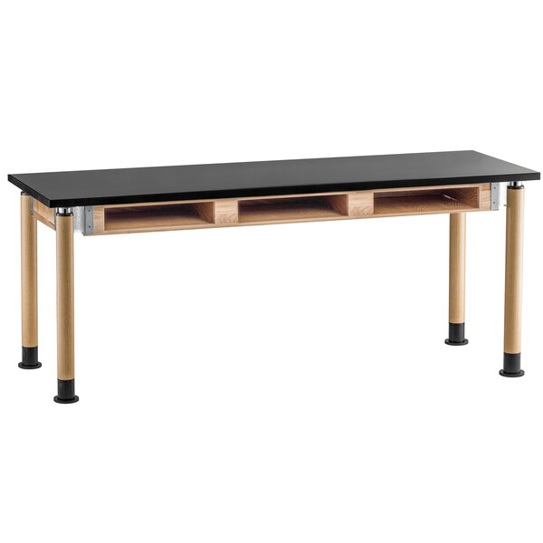 A black and wood National Public Seating science lab table with book compartments.