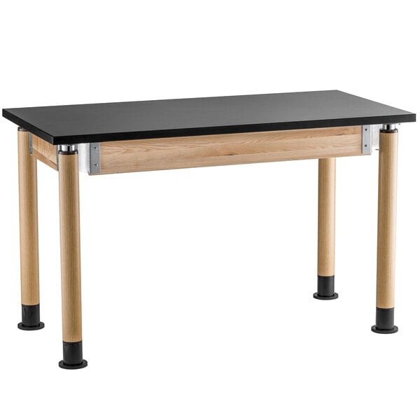 A black science lab table with wooden legs.