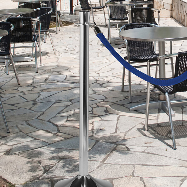 A metal pole with a blue rope tied to it.