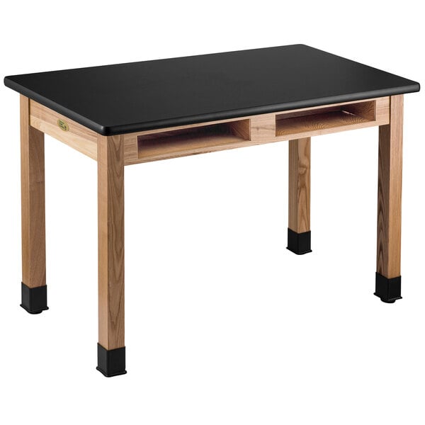 A black science lab table with wooden legs.