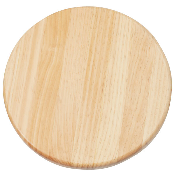 A wooden round seat with a hole in it.