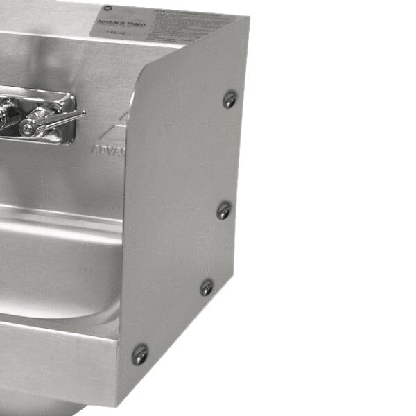 A stainless steel Advance Tabco side splash bolted to a sink with splash mount faucets.