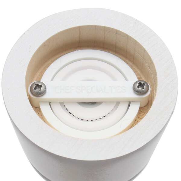 A white circular wooden salt mill and pepper mill set with metal screws.