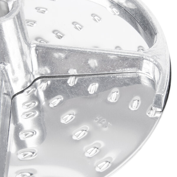 A Robot Coupe 5/64" metal grating / shredding disc with holes.