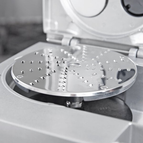 a circular metal object with holes in it