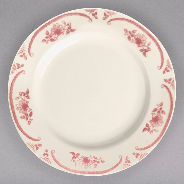 A close-up of a Homer Laughlin American White china plate with pink flowers on it.