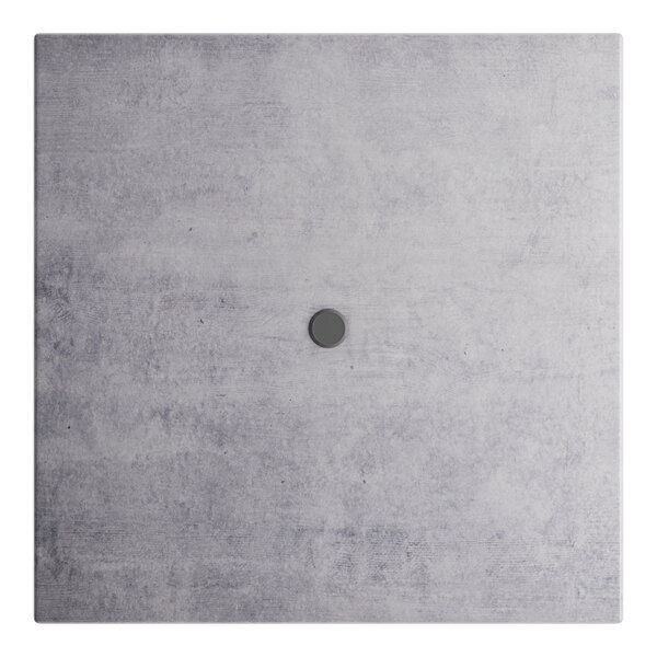 A white square outdoor table with a black square in the middle.