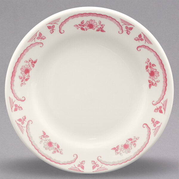 A white Homer Laughlin china bread and butter plate with red roses.