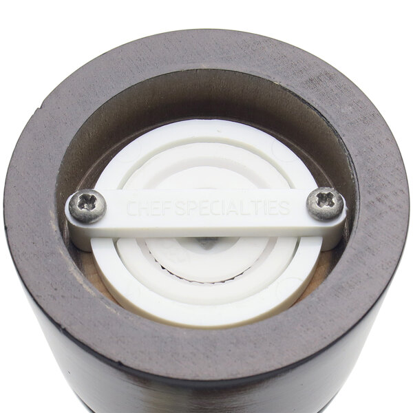 A close up of a gunmetal and white circular grinder valve.