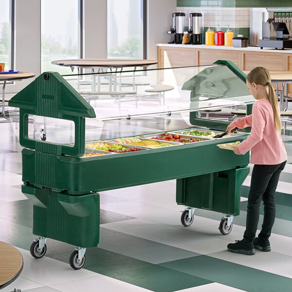 A green portable youth food and salad bar with a clear sneeze guard and multiple food compartments.