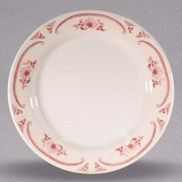 A white Homer Laughlin china plate with red flowers.