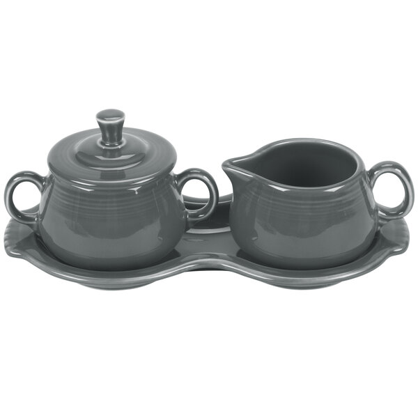 A grey ceramic tray with a Fiesta creamer and sugar bowl set.