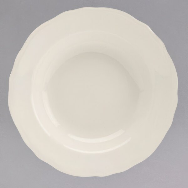A white Homer Laughlin china bowl with a scalloped rim.