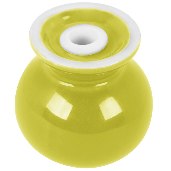 A yellow Fiesta pepper shaker with a white lid.