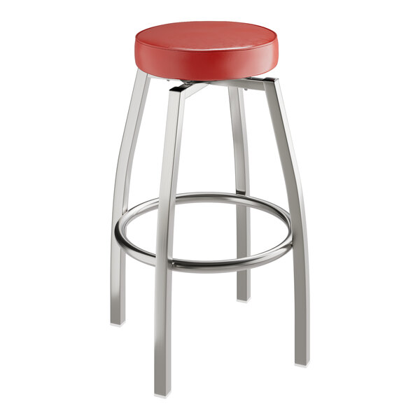 A red Lancaster Table & Seating swivel bar stool with metal legs and a clear coat finish.