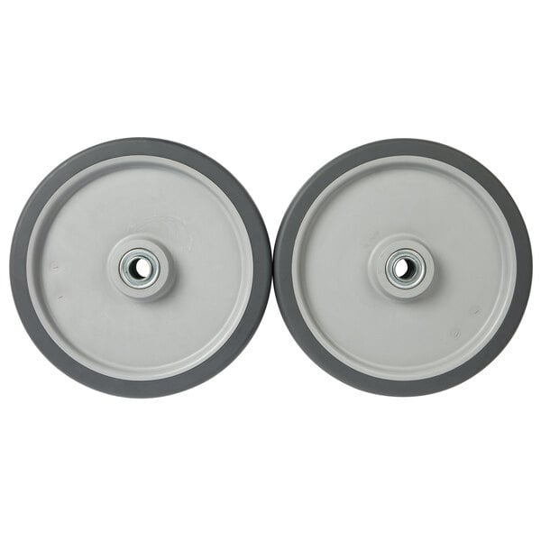 A pair of gray 10" wheels for a tilt truck with a rubber rim and a hole in the center.