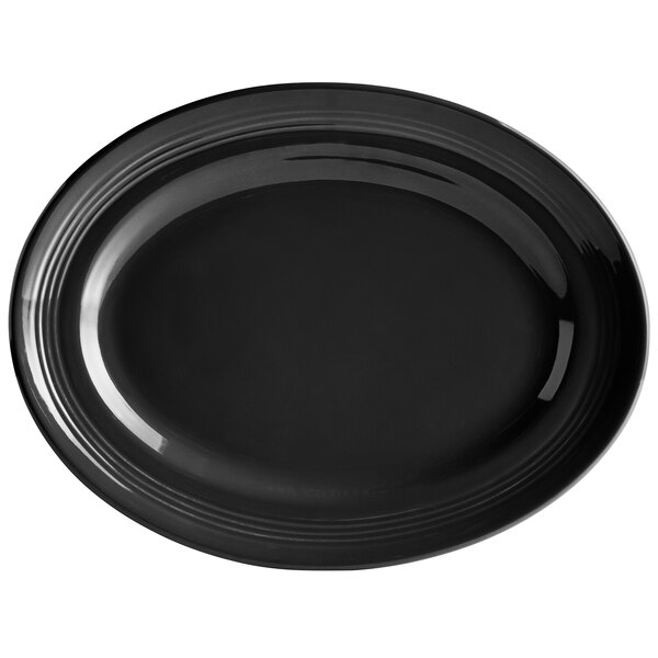 A black oval Tuxton china platter with a rim.