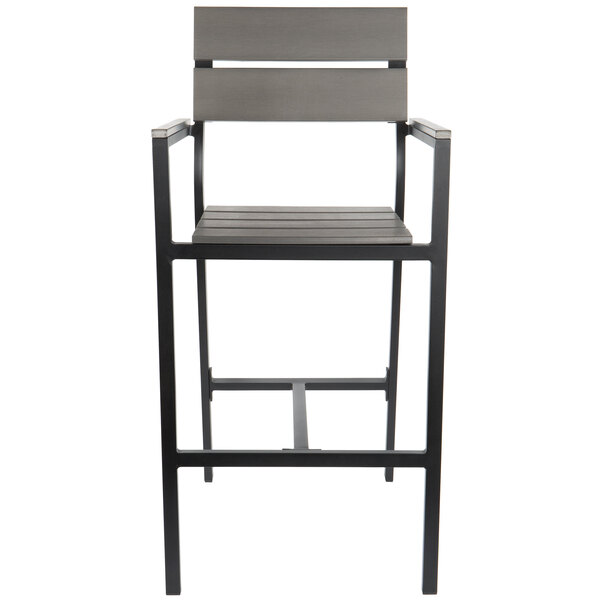 A BFM Seating black aluminum outdoor restaurant bar stool with a gray synthetic teak back and seat.