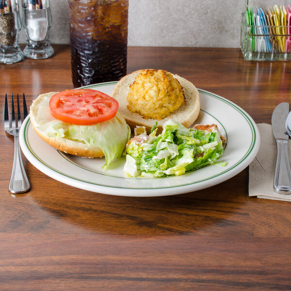 A Homer Laughlin ivory china plate with food on a table.