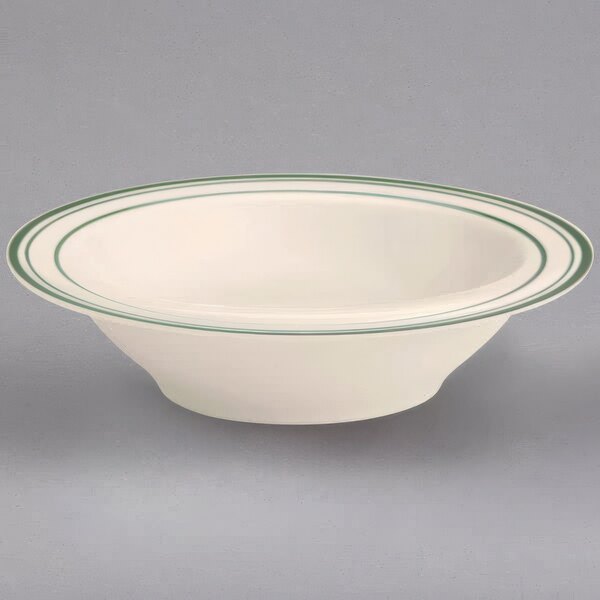 A white bowl with green stripes on the rim.