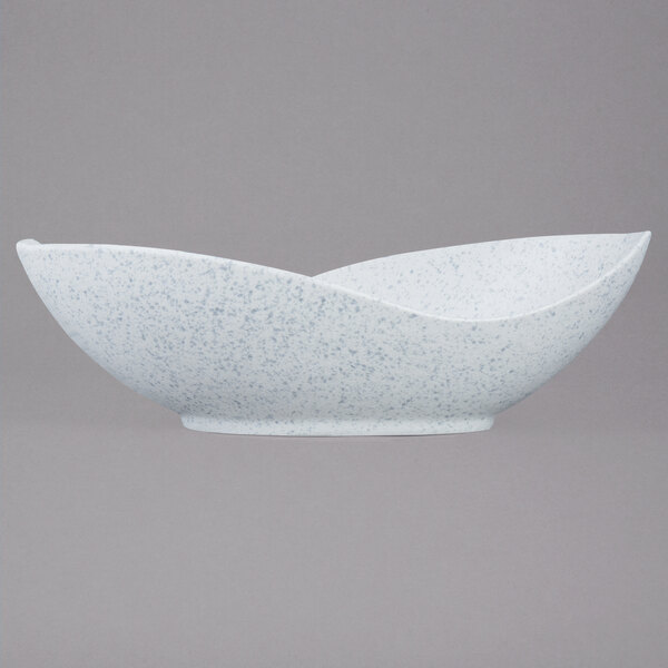 A white porcelain canoe bowl with blue speckled specks.