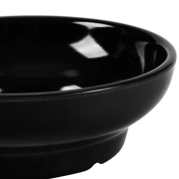 A close up of a black GET Salsa Dish.