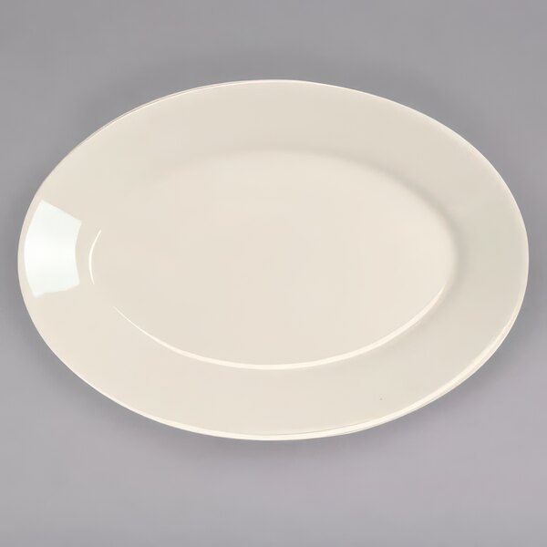 A white oval platter with a rim on a gray surface.