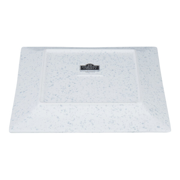 A blue speckled square porcelain dinner plate.