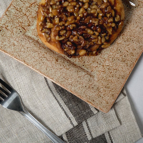 A 10 Strawberry Street Tiger Eye porcelain dinner plate with food on it.