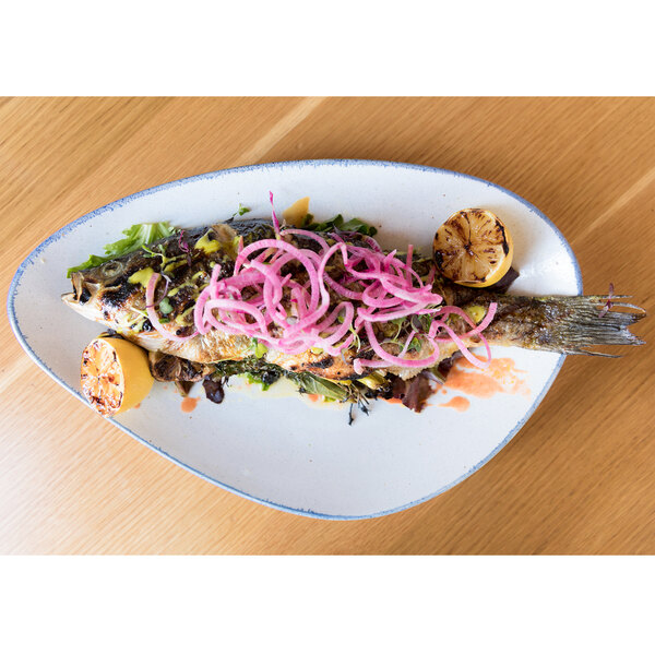 A fish with onions on a 10 Strawberry Street Arctic Blue platter.