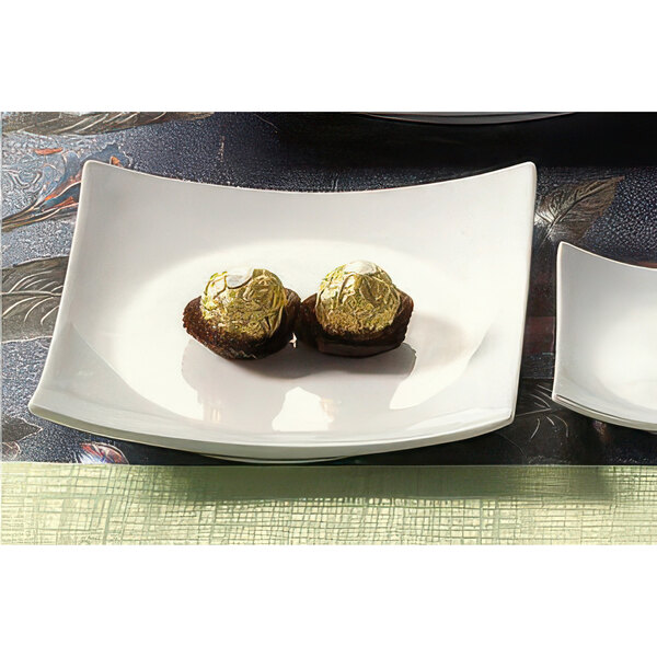A CAC Super White square porcelain plate with sushi on it.