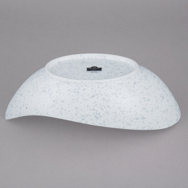 A white bowl with blue speckled spots.