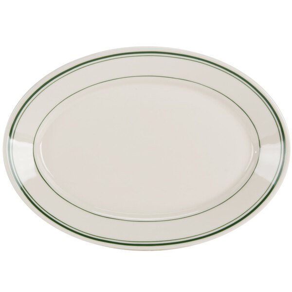 A white oval china platter with green stripes on the edge.
