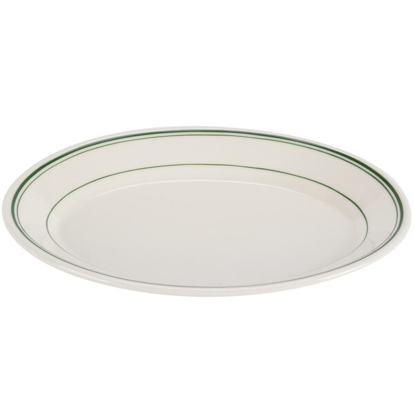 An ivory oval china platter with green stripes on the edge.